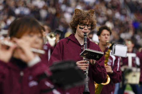 A student plays the clarinet in the crowd.