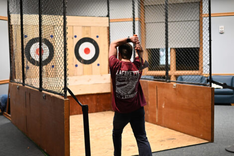 A student throws an axe.