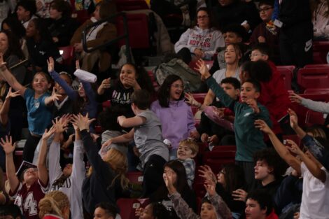EASD students stand in the bleachers at Kirby Sports Center catching T-shirts tossed into the crowd.