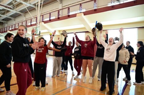 Laf women's softball players jump in the air to celebrate during NGWISD