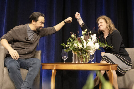 Lin-Manuel Miranda and President Nicole Hurd fist bump on stage