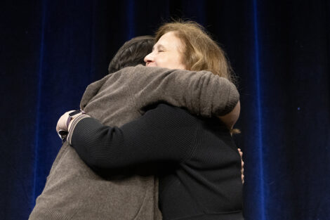 Lin-Manuel Miranda and President Hurd hug.