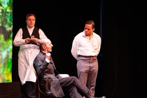 Two people address each other on stage