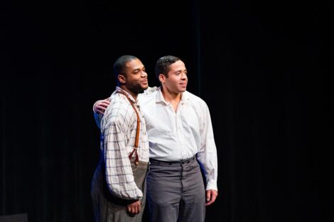 Two people embrace on stage