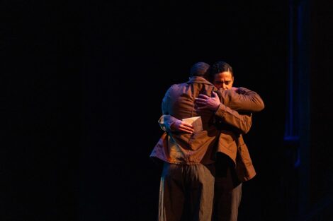 Two people hugging on stage