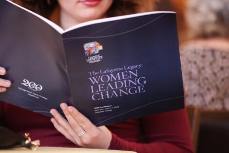 An attendee reads the Conference program
