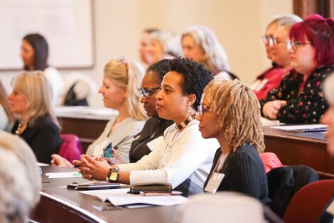 Attendees listen to a presentation at the Conference