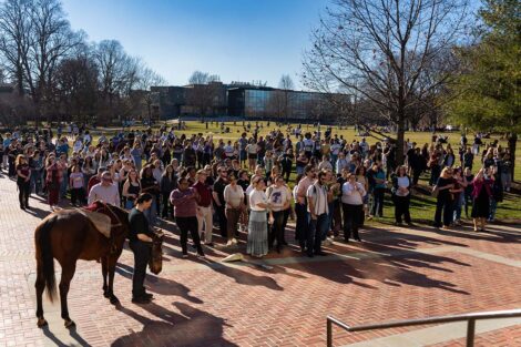 A crowd gathers on the Quad