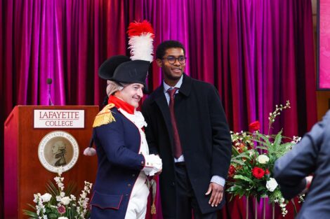 Marquis impersonator shakes hands with an attendee