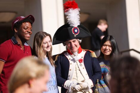 Marquis impersonator poses with students