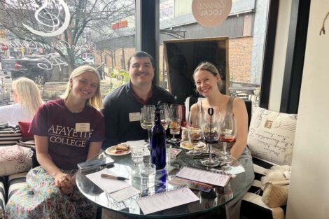 Three people sit at a table