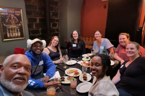 A table of people taking a selfie