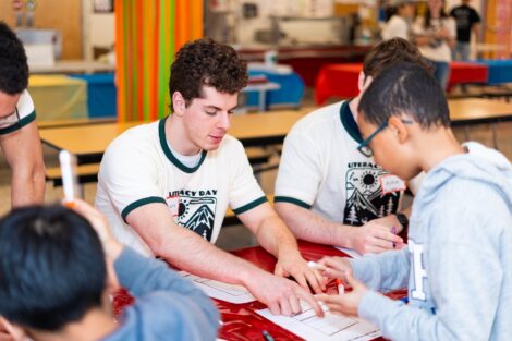 Lafayette student volunteers work with an EASD student at an activity table.