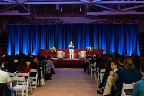 A student stands on stage