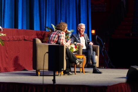 Bill Nye sits on stage with Jenn Rossmann