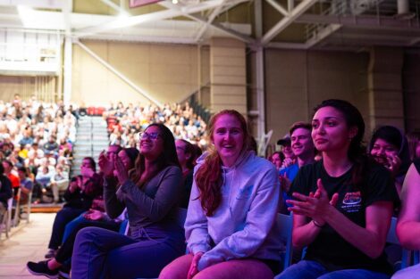 Students smile in the audience