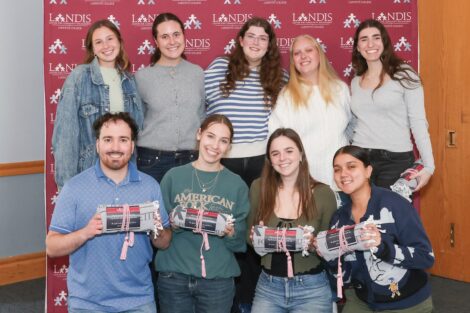 A group of nine Landis volunteers hold up their prizes after the Landis awards ceremony