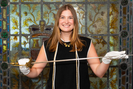 Elizabeth Miller '26 holds sword.