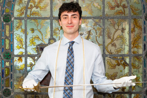 Alexander Brown '26 holds sword.