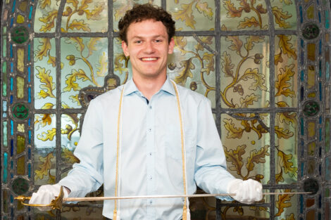 Ben Risley '26 holds sword.