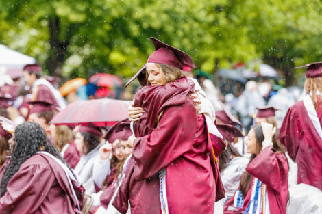 Two graduates hug