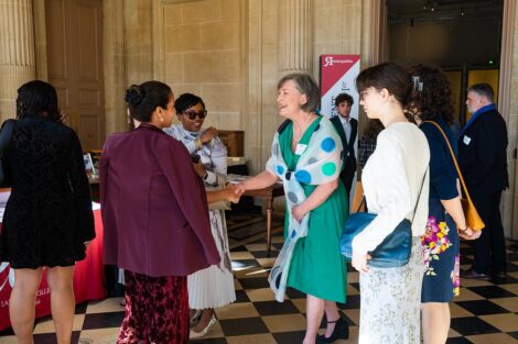 Stomber greets Trustees Tanuja Majumdar Dehne '93 (left) and Kamaka Martin '04.