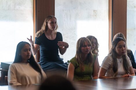 A student stands up to ask a question of the panel.