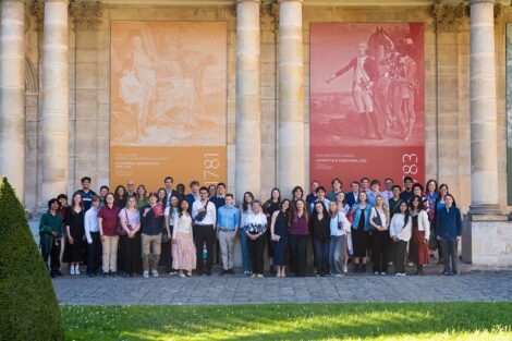 Group shot of students and alumni in front of Lafayette artwork