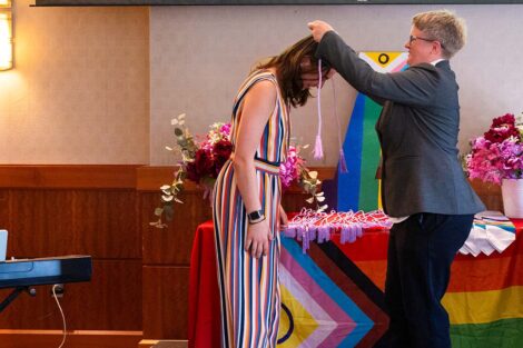 A student receives their cords at Lavender Celebration