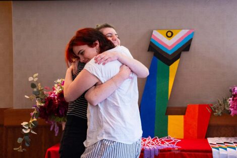 A student hugs another at Lavender Celebration