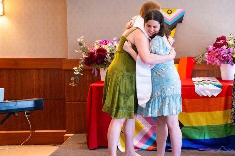 A student hugs another at Lavender Celebration