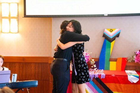 A student hugs another at Lavender Celebration