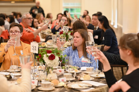 Faculty raise their glass in cheers.