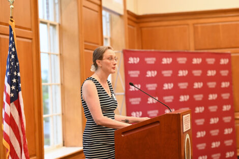 Alex Hendrickson speaks at a podium.