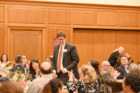 A faculty member stands up during the Faculty/Staff Awards.