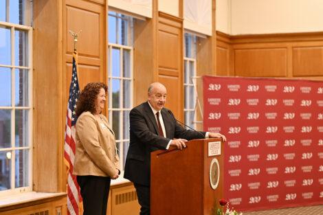 Bob Sell speaks at the microphone with Sandra Rodgers