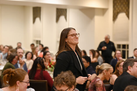 A person stands in the crowd.