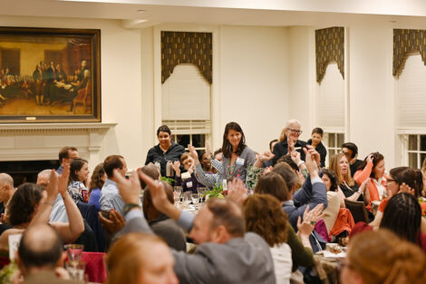Staff members clap.