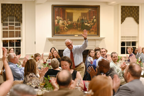 A faculty member waves.