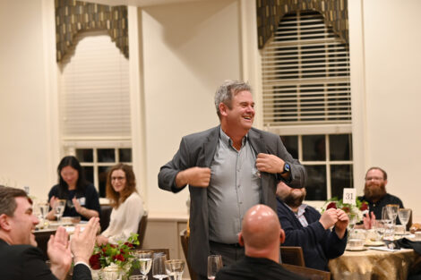 A faculty member stands up during the Faculty/Staff Awards.