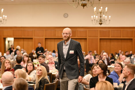 A faculty member stands up during the Faculty/Staff Awards.