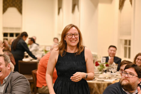 A faculty member stands up during the Faculty/Staff Awards.