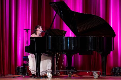 A person plays piano at Baccalaureate