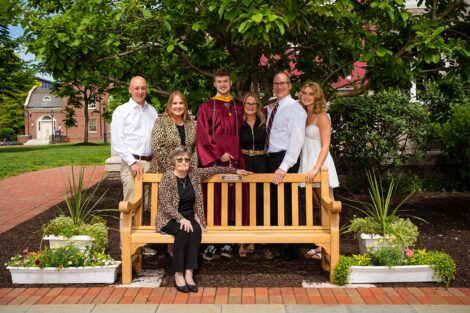 The family of Aidan Boudreaux stand by a memorial bench.