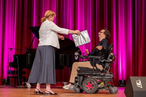 President Hurd goes to hug Dexter Kennedy at Baccalaureate