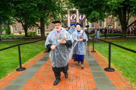 Mace barer leads the faculty in procession.