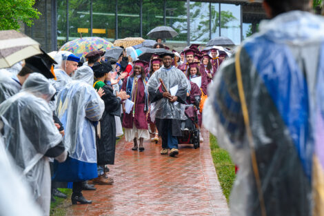 Graduates smile during the procession.