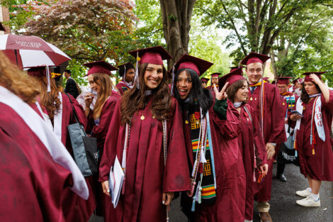 Graduates smile during the procession.