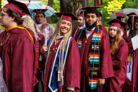Graduates smile during the procession.
