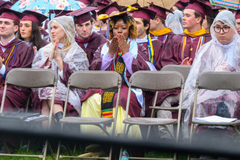 A student blows kisses in the crowd of graduates.